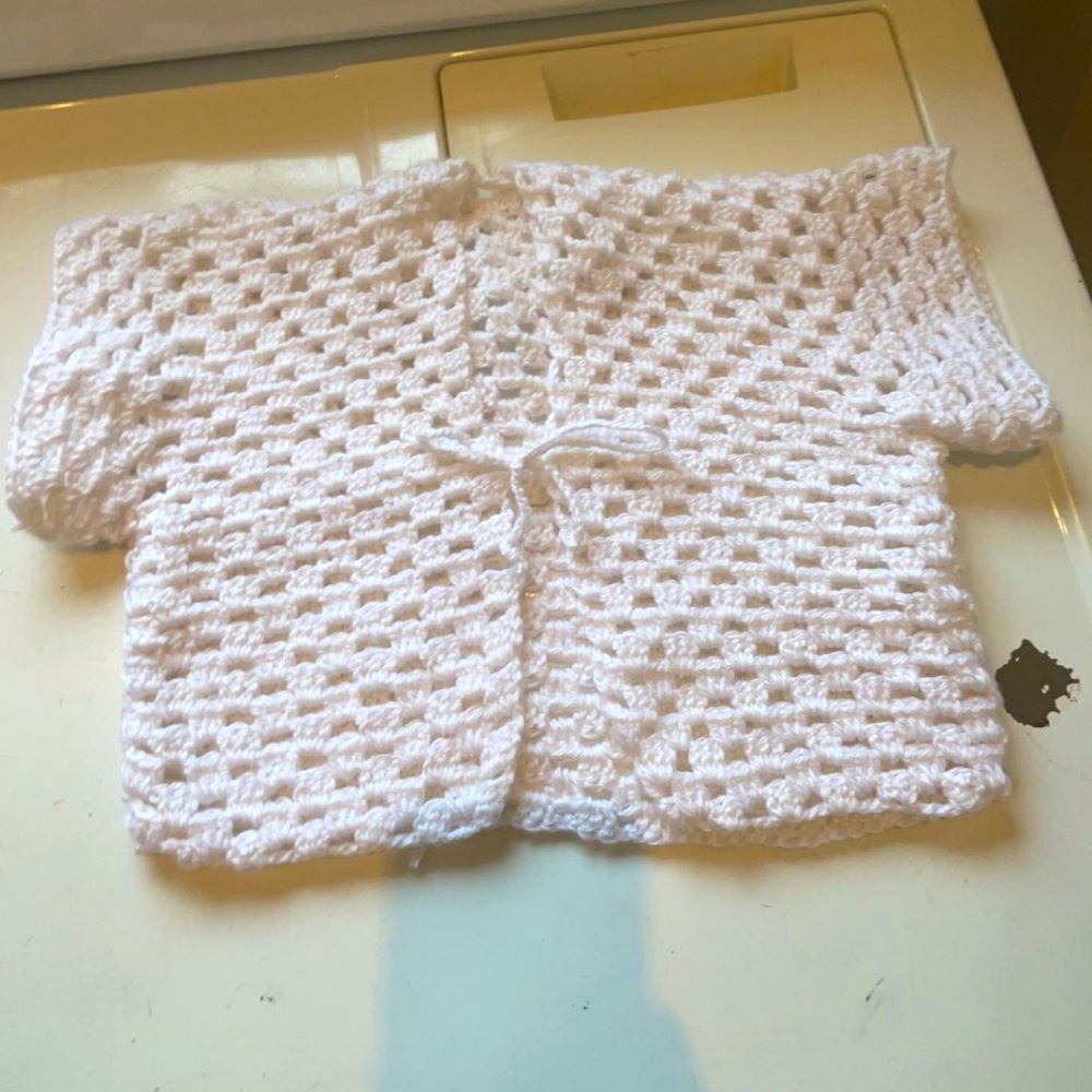 Soft, white hand made crochet cardigan cover up top.